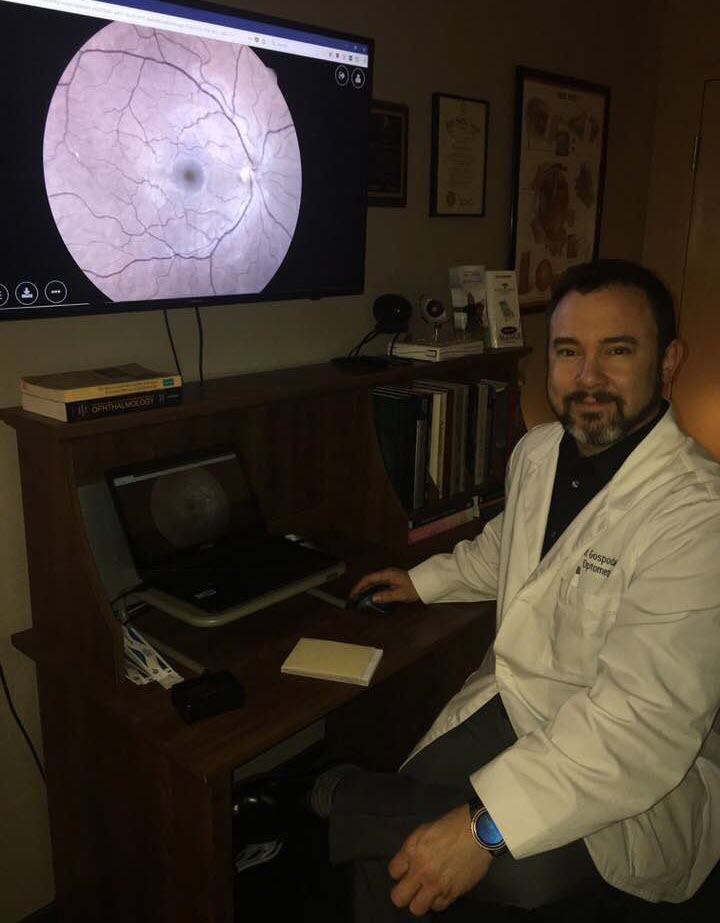 Dr. Gospodarek reviewing a retinal scan on screen in his exam room